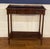 This is a mahogany hall console table by Leighton Hall. It has a brass gallery and a dovetailed drawer with brass pulls....