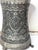 This is an antique Persian silver-washed copper can from the late 19th century. It has beautiful hammered engraving with...