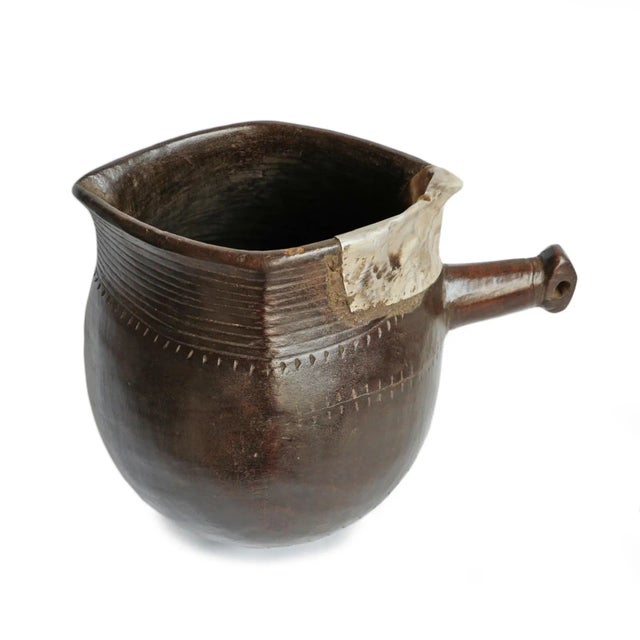 Vintage handmade village pitcher from North Africa. Rich dark wood with original aluminum repairs and traditional...