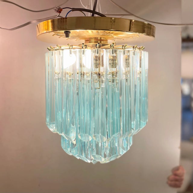 Pop and classic flush-mounted pendant light made of 44 blue striated full-tubes Murano glass suspended on a golden...