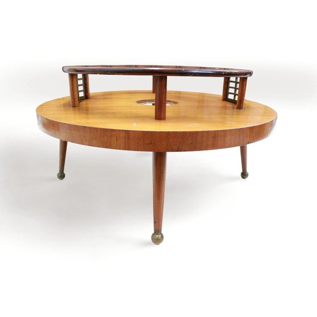 This beautiful and interesting round coffee table comes to you probably from a period a little bit earlier than the MCM...