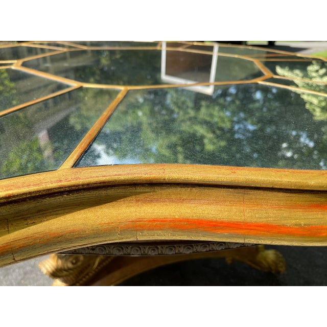 Three beautifully hand carved dolphins rest on a three sided burr Walnut inlaid platform. Their tails support an antique...