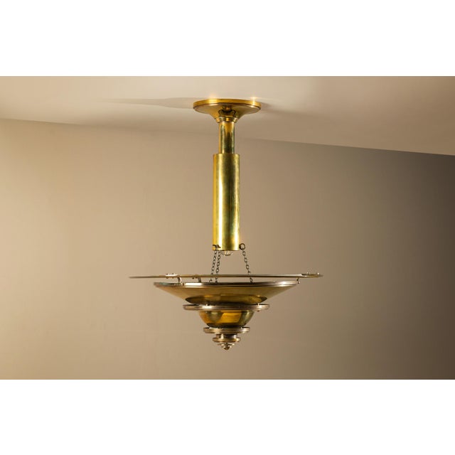 A calm and well-balanced design, this hanging lamp shows the clarity typical of early french art deco lighting. The...