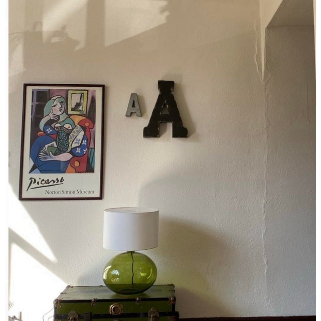 A striking vintage exhibition poster featuring Pablo Picasso’s iconic Woman with Book (1932), beautifully framed and ready...