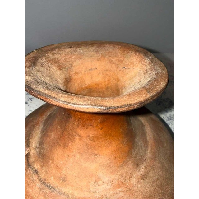 This antique terracotta vessel from Peru is a beautifully balanced example of traditional Andean pottery, distinguished by...