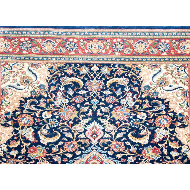 A beautiful mid-20th century Persian Kashan rug with a traditional central floral medallion living amidst a field of...