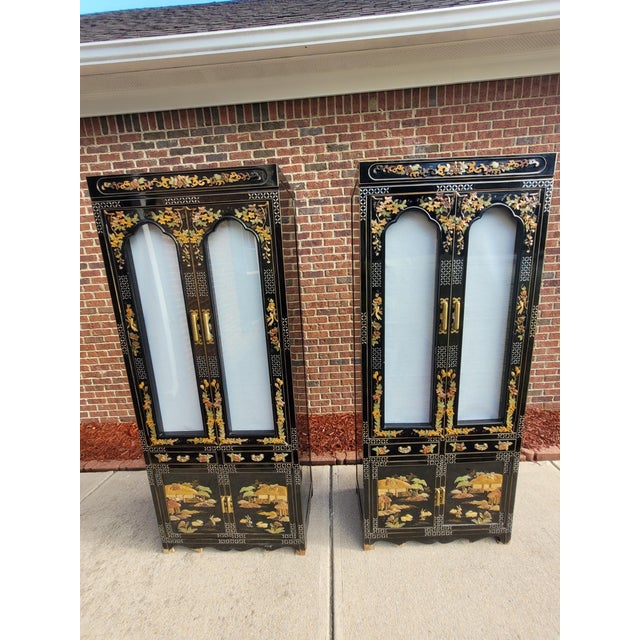 Vintage Chinese Chinoiserie cabinet featuring a beautifully aged, traditional Asian-inspired design with rich wood...