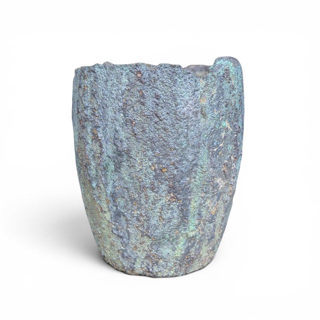 A substantial antique industrial refractory crucible, transformed by decades of foundry use into a sculptural vessel with...