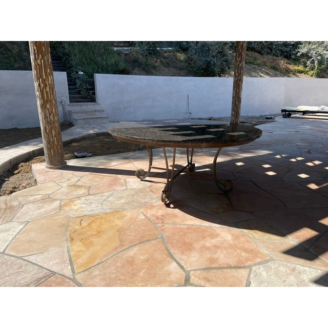 This is a generous sized custom made granite top dining table for outdoor/indoor use. The frame is iron and the top is...