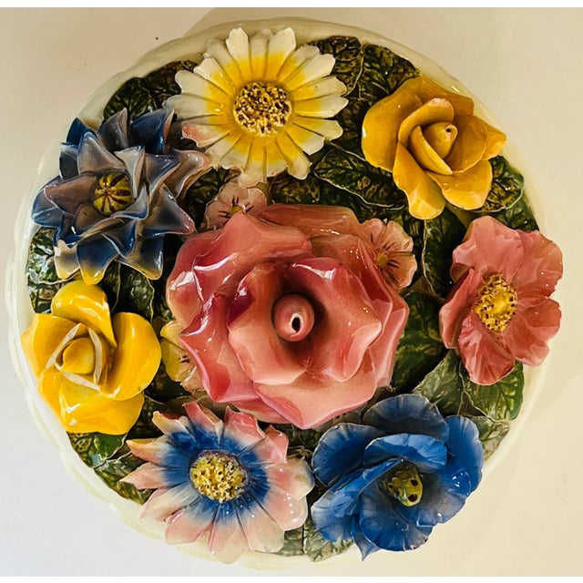 Charming covered bowl with lower bowl having melon sides. The lid is adorned with beautifull sculpted flowers.When you...