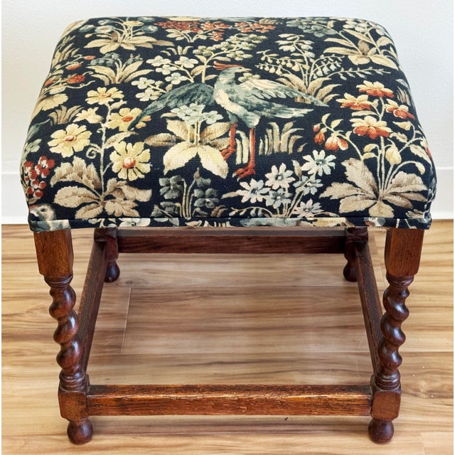 Vintage English style wood stool featuring barley twist legs and colorful tapestry style upholstery. Measures 17.5"H....