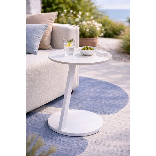 Serene tables add a clean, modern touch to any space. The slim side table features an angled metal base and a marble-style...