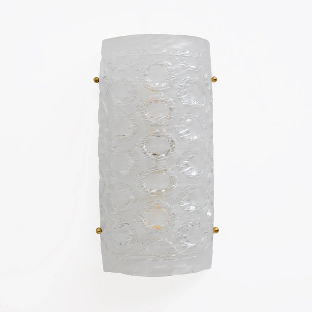 Pair of vertical and cylindrical wall lamps in crystal-colored Murano glass, textured glass with honeycomb workmanship....