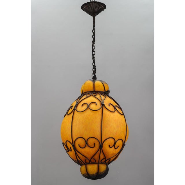 Venetian Style Pâte de Verre glass metal caged lantern pendant light, France, 1970s. Impressive and large hand-blown Pâte...