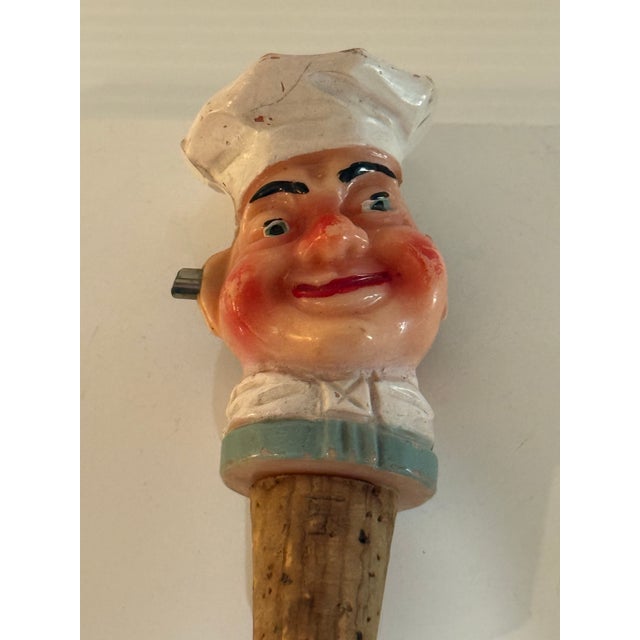 Charming vintage figural chef bottle pourer featuring a smiling chef head rendered in painted hard plastic with cork...