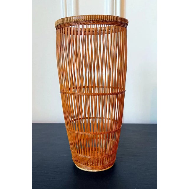 A Japanese ikebana basket constructed woven by bamboo artist Abe Motoshi (Japanese, b. 1942). Constructed with Madake...