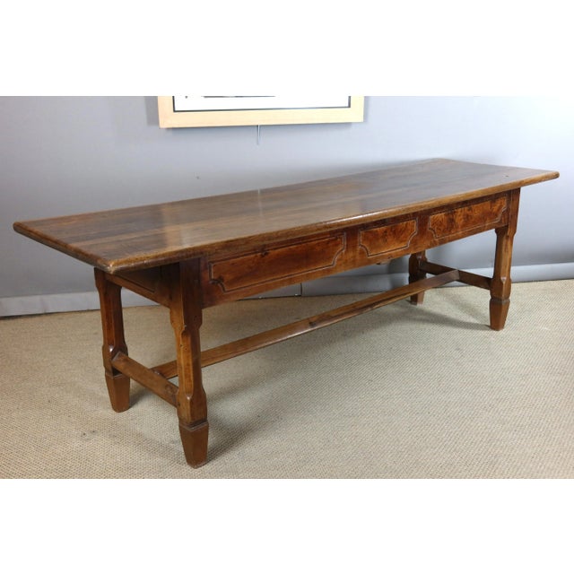 Large eighteenth-century walnut serving table. This table features a drawer and two storage compartments on either side of...