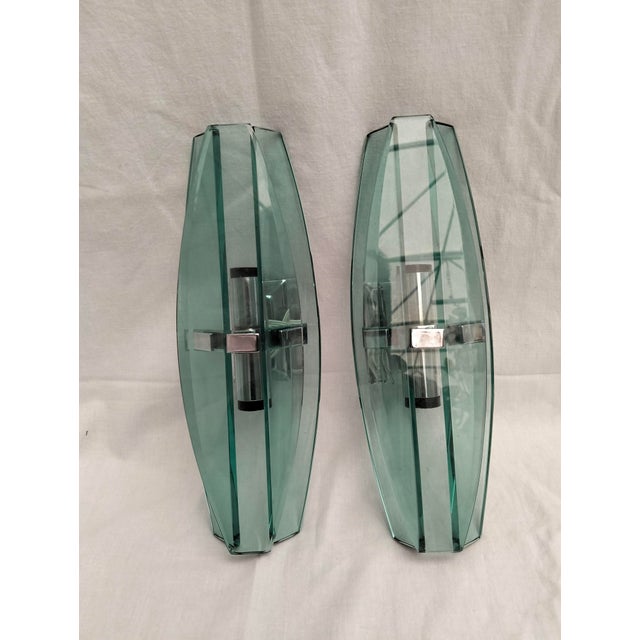Pair of sheet glass wall lamps with beveled edges. Nickel-plated metal frame. Two E14 lamp holders suitable for LED or...