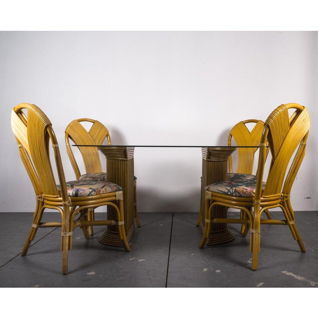 Rattan table and 4 chairs from the 1980s. The oval glass plate lies on a rat base that can be moved variably. The 4 chairs...