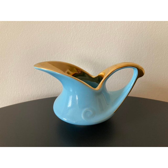 A beautiful turquoise blue and gold creamer, USA, circa mid 20th century. Piece showcases the MCM American design. This...