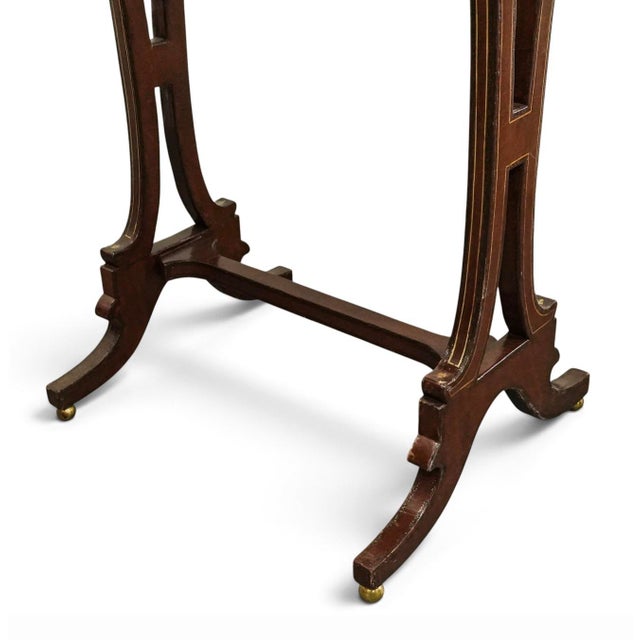 Maitland Smith Materials: Wood, leather, brass Central game table component lifts to reveal the gold tone metal plaque...