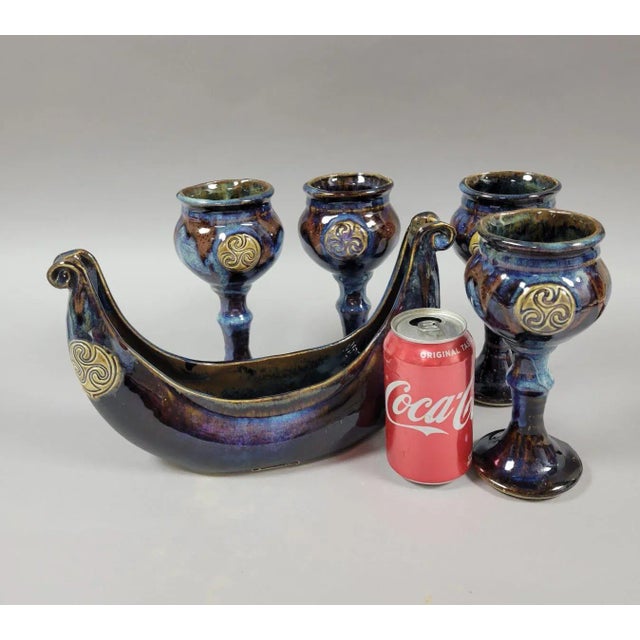 Richly glazed set of 4 pottery goblets and a Viking ship bowl by Irish potter Colm De Ris. Individually thrown and glazed...