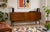 A1960s Tola sideboard by Nathan, featuring three wide drawers, a shelved double cupboard and a drop-down cupboard to the...