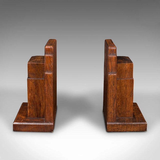 This is a vintage pair of decorative bookends. An English, oak book rest, dating to the early 20th century, circa 1930. A...