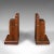 This is a vintage pair of decorative bookends. An English, oak book rest, dating to the early 20th century, circa 1930. A...