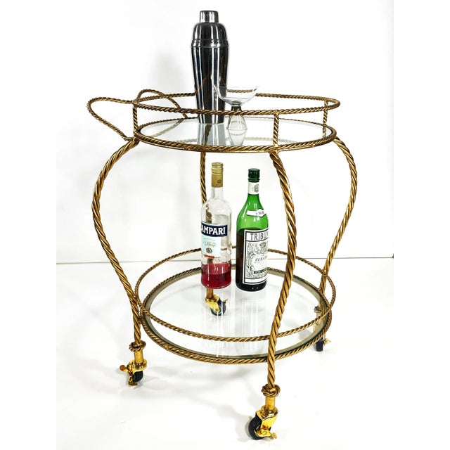 A stunning vintage Italian gilt iron rope bar cart straight out of the 1960s Hollywood Regency era. Hand-forged in Italy...