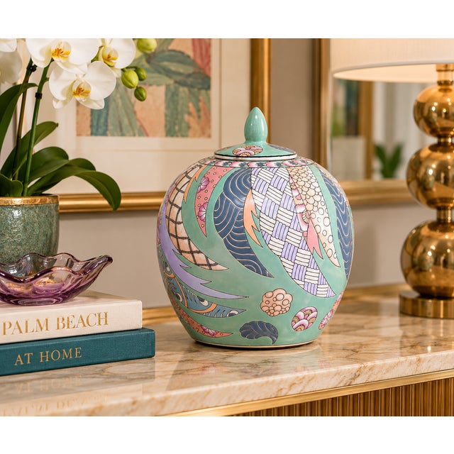 Striking decorative Chinese ginger jar featuring a soft celadon green ground with an intricate multicolor design in pink,...