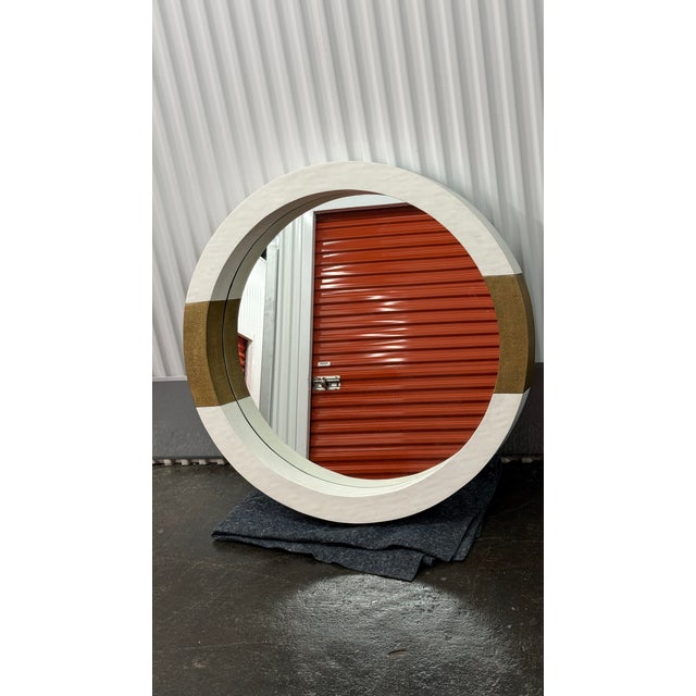 Statement-size Asti wall mirror by Mr. Brown London. Features a deeply sculpted round frame in an ivory/white finish with...