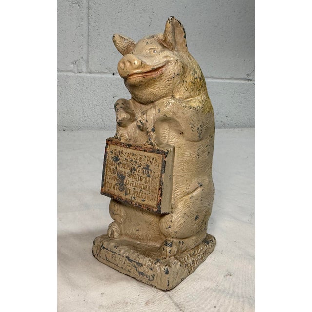 The Antique hand painted "Thrifty be Wise Pig" cast metal still bank is an original collectible piece made of metal in the...