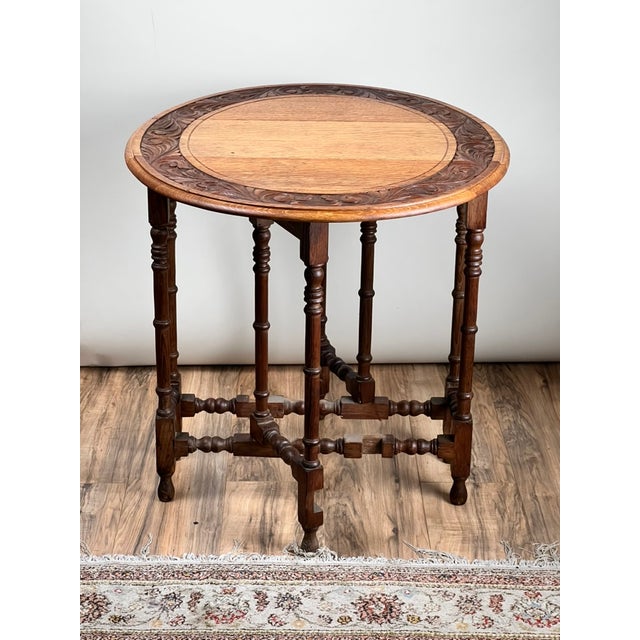 A particularly charming late 19th century English oak gateleg table, distinguished by its richly carved frieze and warm,...