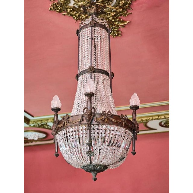 Restored castle chandelier made of bronze, hand-cut and polished crystal and glass lampshades in the shape of a torch. The...