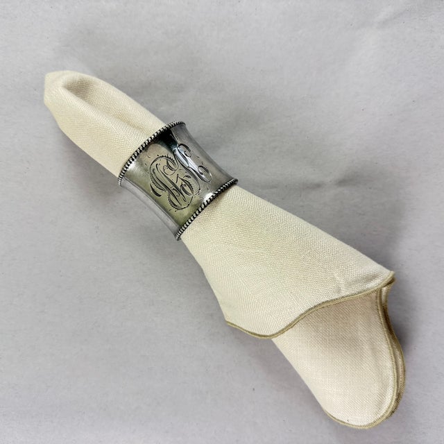 A heavy round cinched waist sterling silver napkin ring with heavy beaded ends, circa 1900-1920. Substantial applied...