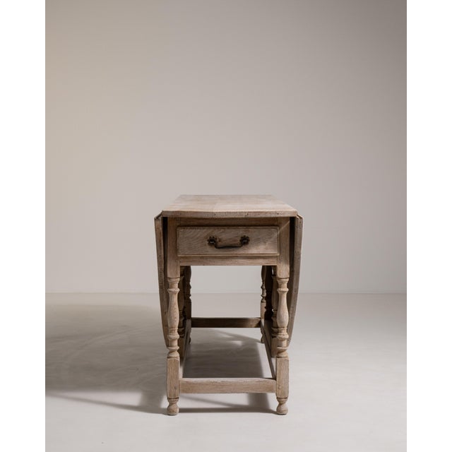 A versatile drop-leaf table designed for flexible use, with folding sides that allow it to expand or contract as needed....