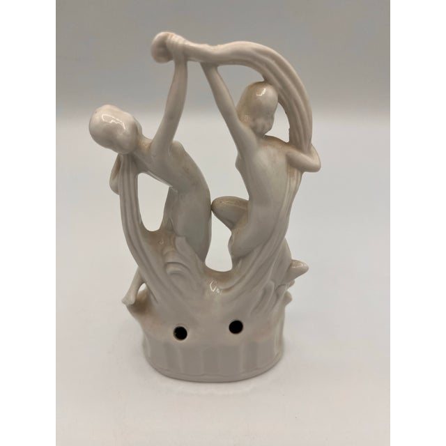 Two graceful nymphs in “Scarf Dancer pose, representing grace and movement. Porcelain flower frog with mold number 4386...
