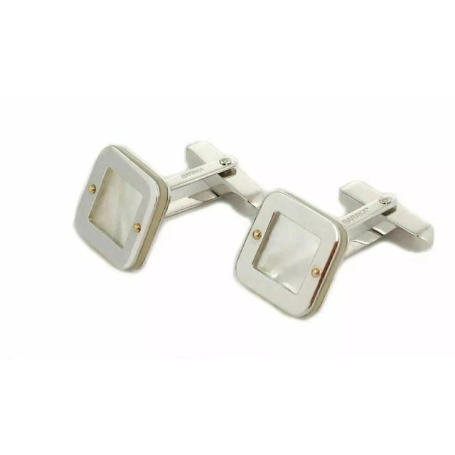 This is an authentic elegant pair of cufflinks by designer Baraka, they are crafted from 18k white gold with a high...