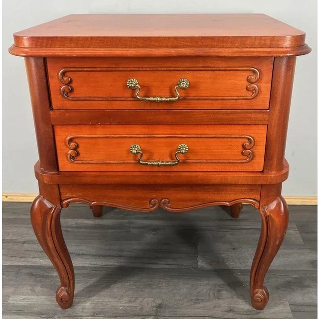 A beautiful vintage French Louis-style bedside table , featuring classic cabriole legs, elegant brass handles, and smooth...