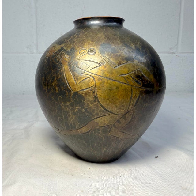 This antique Japanese bronze vase features beautiful hand tooled frog scenes accented by a lovely hand hammered finish....