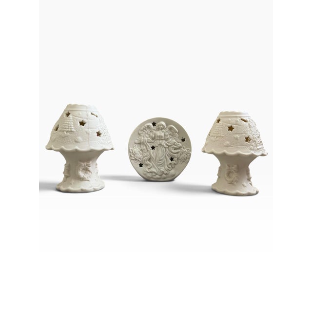 Charming vintage three-piece ceramic angel luminary set featuring two matching tealight holders and a coordinating plug-in...