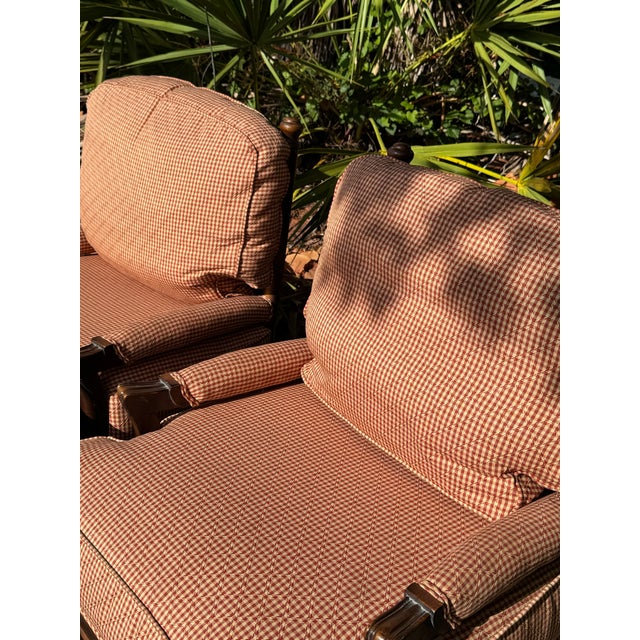 A charming pair of custom ladder back lounge chairs by Walter E. Smithe, featuring solid wood frames and classic red...