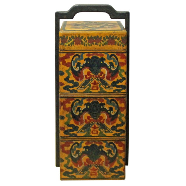 This Chinese three-tier lacquered picnic box, or tixi, features a stacked square construction held within a sturdy, dark-...