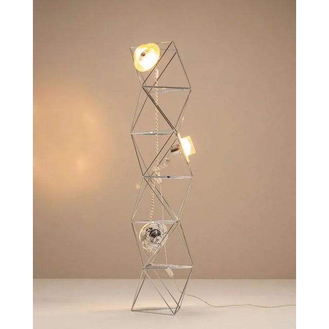 An architectural play of light and geometry, this “Poliedra” lamp designed by architect Felice Ragazzo for Guzzini...