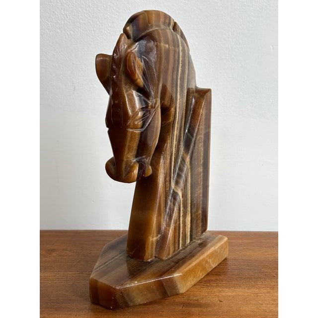 An Art Deco trojan horse onyx bookend. Made in the Machine Age and cut from beautifully veined brown onyx. Please see...