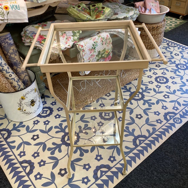 Two vintage metal utility style side tables. Three glass shelves and two towel bars on the sides. One is slightly yellowed...