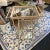 Two vintage metal utility style side tables. Three glass shelves and two towel bars on the sides. One is slightly yellowed...