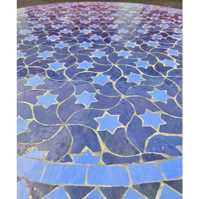 Beautiful handcrafted Moroccan mosaic table featuring an elegant blue color palette. Measuring 40 inches in diameter, this...