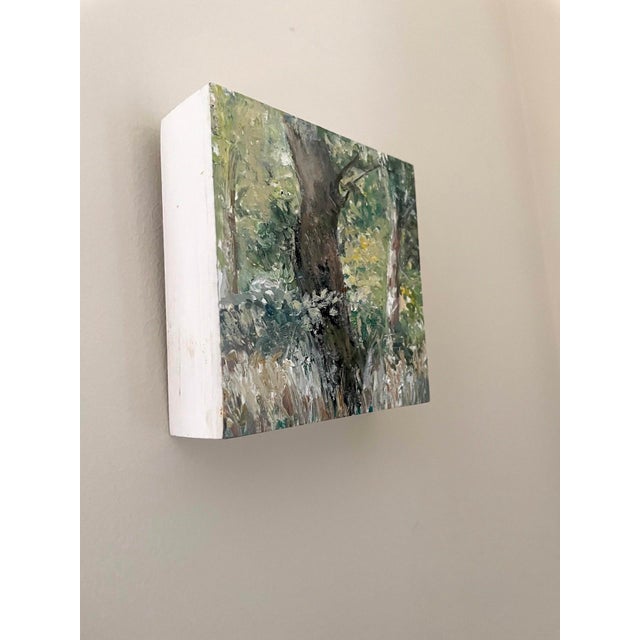 This artwork captures a serene forest edge, where lush greenery meets the textured bark of a tree. The vibrant brushwork...